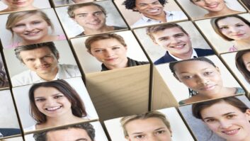 Photos of people's faces on wooden blocks, with one block missing in the middle