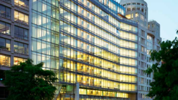 A 13-story office building brightly lit from within.