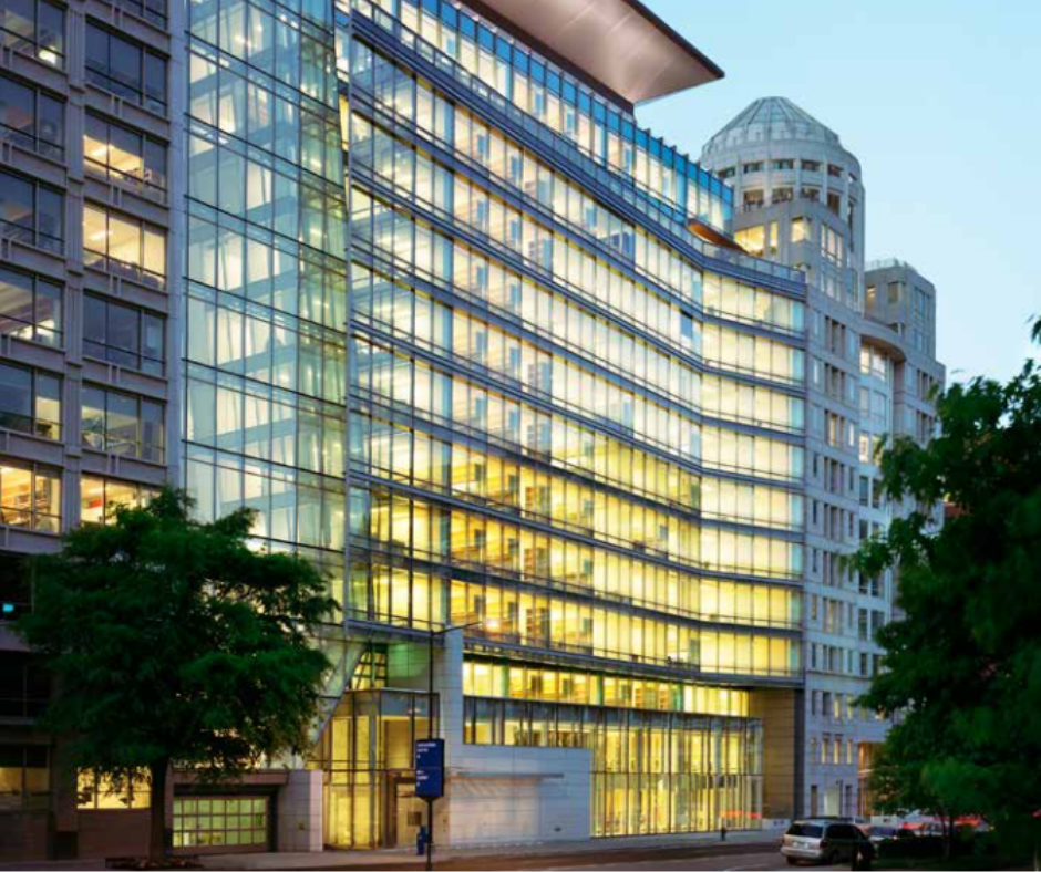 A 13-story office building brightly lit from within.