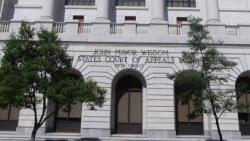 Front steps of a courthouse building, with a sign "John Minor Wisdom United States Court of Appeals Fifth Circuit"