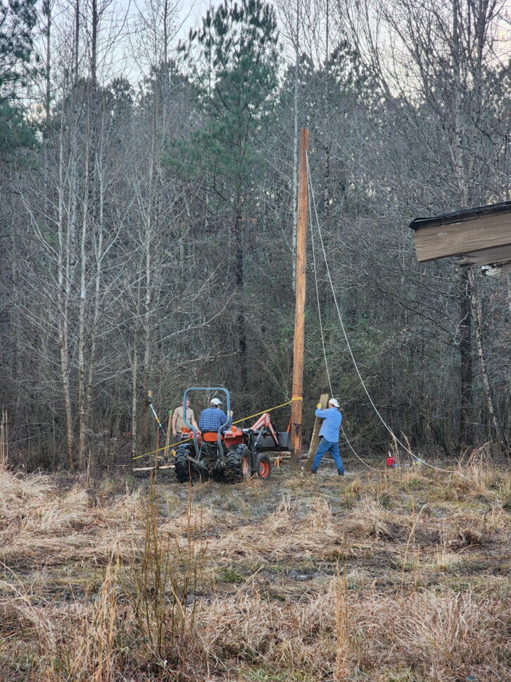 A crew sets up a power pole at WJLX(AM)'s transmitter site in Jasper, Ala.