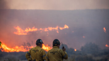 Firefighters are silhouetted by flames from the Hughes Fire in northwest Los Angeles County in January. Credit: APU GOMES/AFP via Getty Images